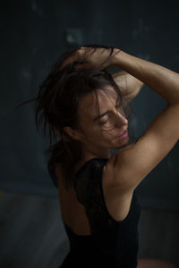 Close-up of woman with closed eyes standing at home