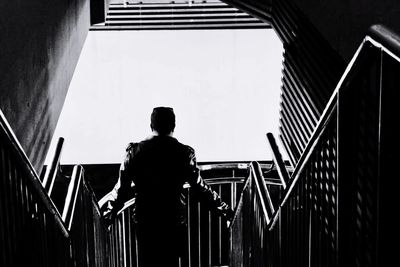 Low angle view of woman standing on staircase