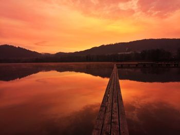 Scenic view of lake against romantic sky at sunset