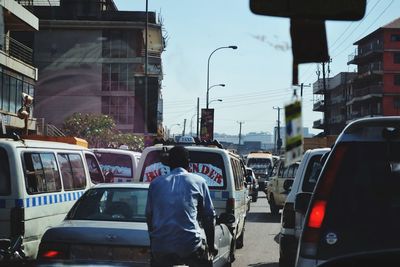 Rear view of people on street in city