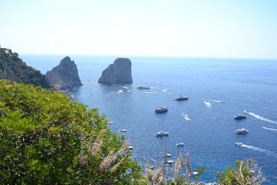 High angle view of boats in sea against clear sky