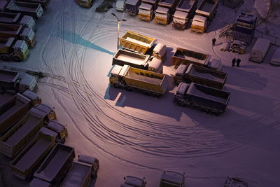 High angle view of vehicles on snow covered road at night