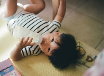 High angle view of mother holding baby at home