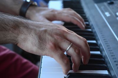 Midsection of man playing piano