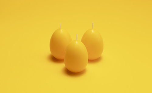 Close-up of figurine against yellow background