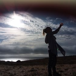 Man standing at beach against sky