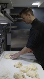 Side view of man working on table