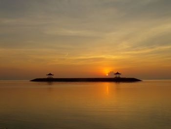 Boat sailing in sea at sunset