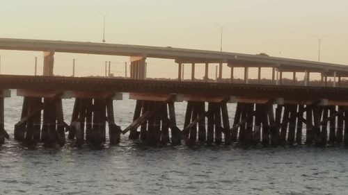 Bridge over sea against sky