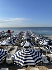 High angle view of chairs on beach against sky