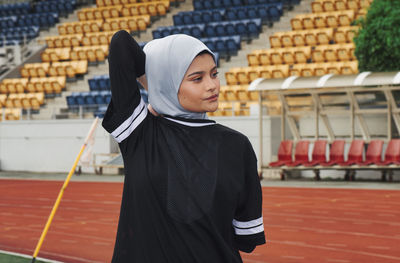 Athlete wearing hijab while exercising on sports track