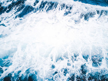 High angle view of waves splashing in sea