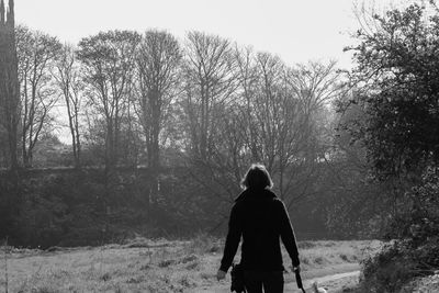 Rear view of a man walking on trees