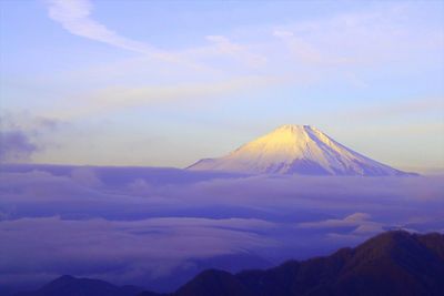 Scenic view of mountains against cloudy sky