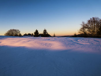 Scenic view of frozen landscape against clear sky