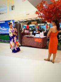 Full length of woman standing in shopping mall