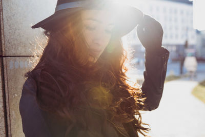 Portrait of well dressed woman standing in sunlight