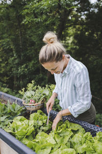 Woman eating food on plant