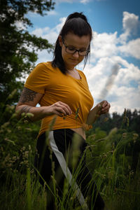Woman standing on field against sky