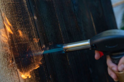 Close-up of hand holding cigarette