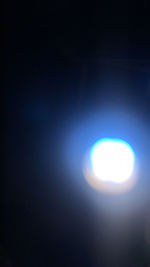 Low angle view of moon against blue sky at night