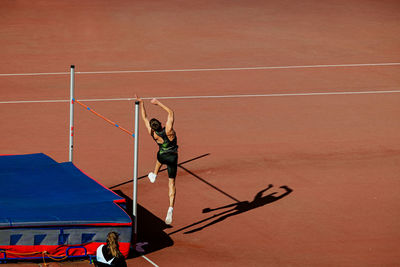 Male athlete high jump in athletics competition