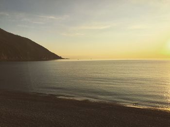 View of calm beach at sunset