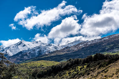 Scenic view of mountains against blue sky