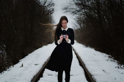 Full length of woman on snow covered field