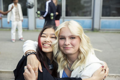 Portrait of smiling female friends embracing