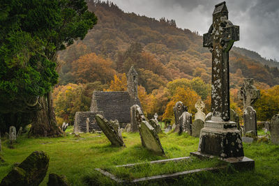 Medieval church ancient graves celtic crosses in glendalough cemetery, ireland