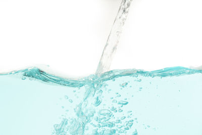 Close-up of water splashing on white background