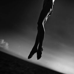 Midsection of man in water against sky at night