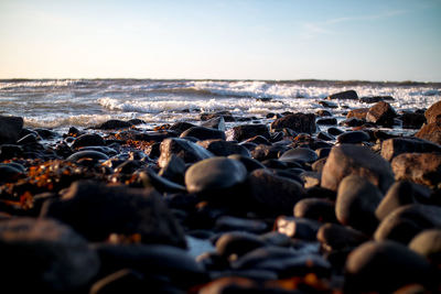 Rocks on beach against sky