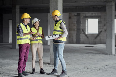 Architects discussing together at construction site