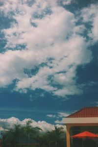 Low angle view of building against cloudy sky