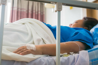 Female patient relaxing on bed at hospital