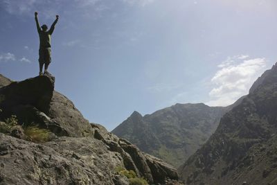 Low angle view of mountain against cloudy sky