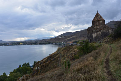 Panoramic view of historic building by mountain against sky