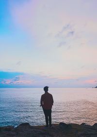 Rear view of boy standing on beach