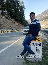 Portrait of young man on road