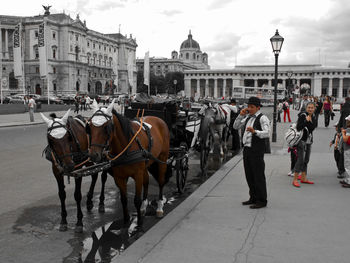 Panoramic view of people on street in city