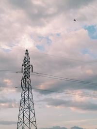 Low angle view of birds on electricity pylon against sky