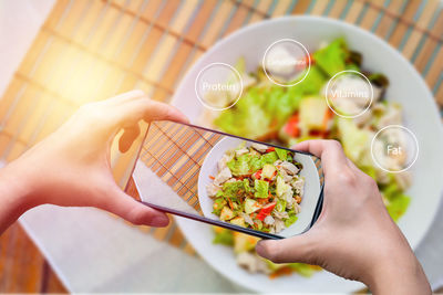 Midsection of person holding bowl of food