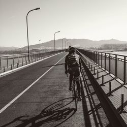 Two people riding on road