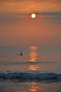 Scenic view of sea against orange sky