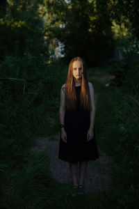 Portrait of young teenage girl standing on land