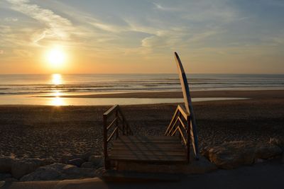 Scenic view of beach against sky during sunset