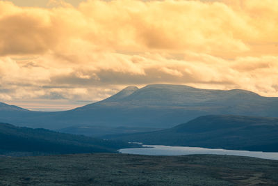 Scenic view of snowcapped mountains against sky during sunset