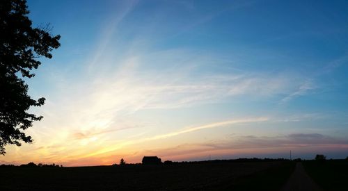 Scenic view of landscape against sky at sunset